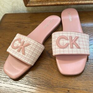 NWOT Calvin Klein Yides Pink flat Sandals. Pink & cream with pink CK letters.
